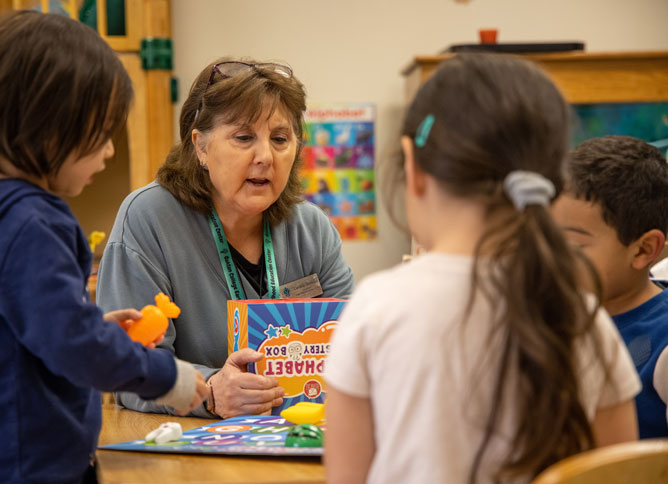 An image of students working with a teacher at the ECE Center.