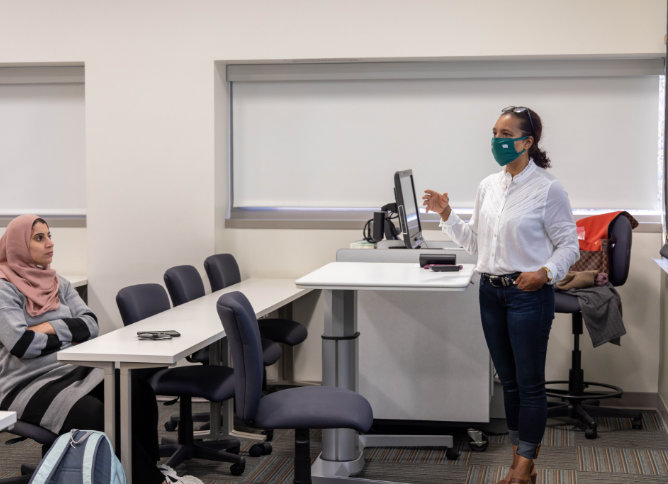 A professor teaches class at Oakton College.