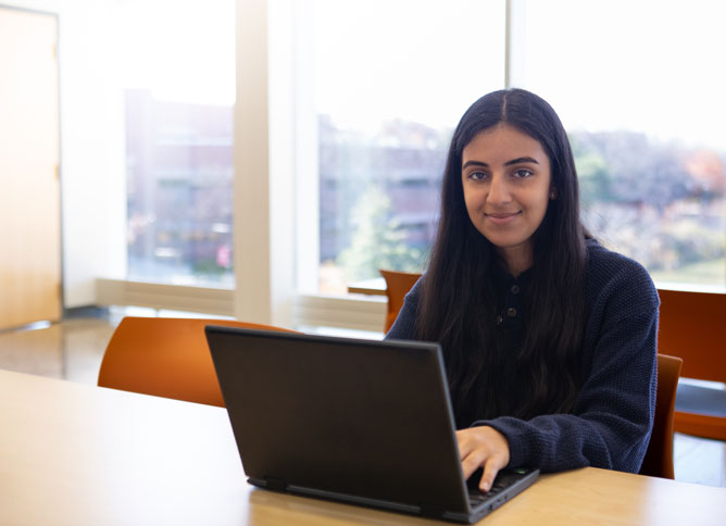 Student studying with a computer.