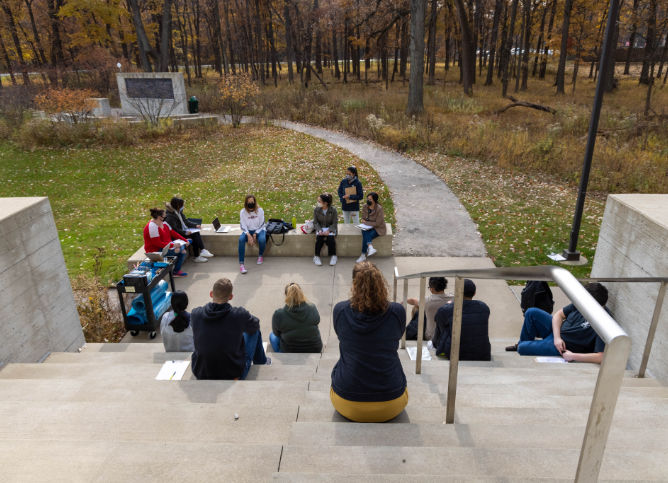 Classroom sitting on steps outside.