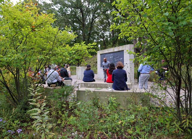 Outdoor classroom framed by green trees.